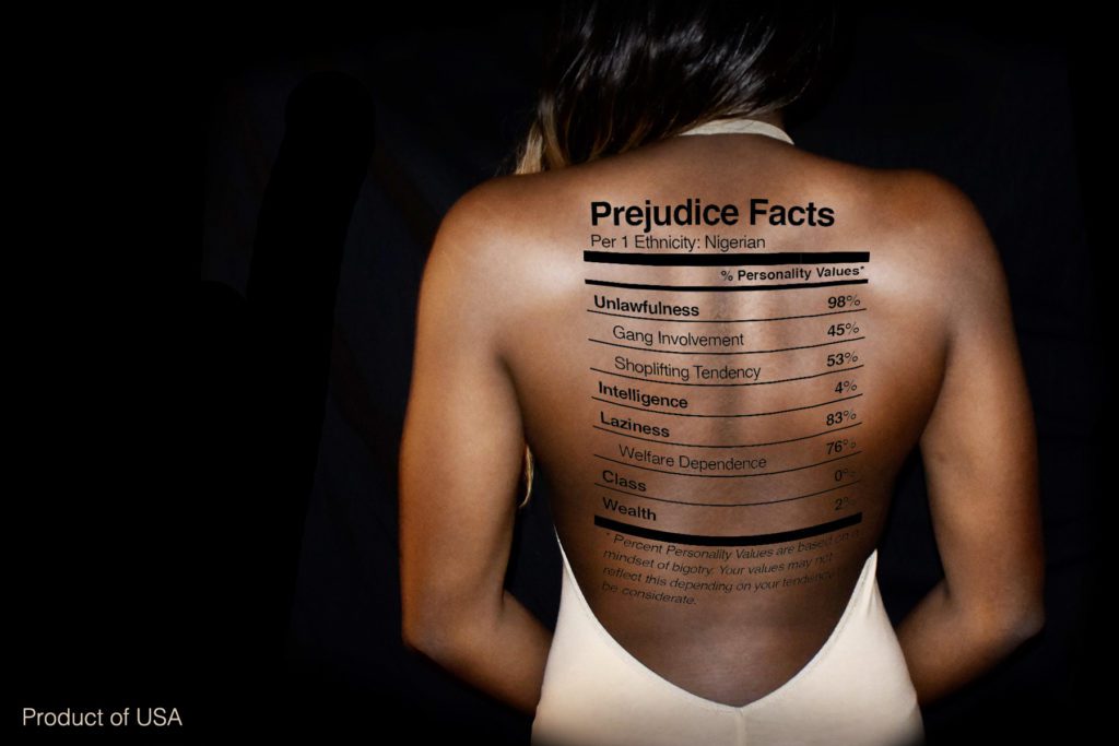 A black woman's back with a graphic that is reminiscent of a nutrition label on it, with common and harmful stereotypes written on each line.